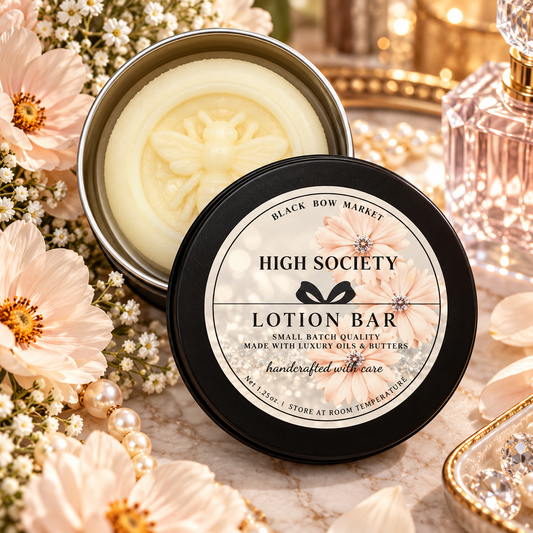 High Society solid lotion bar in an open reusable tin with soft florals and pearls, handmade by Black Bow Market in Keller, Texas