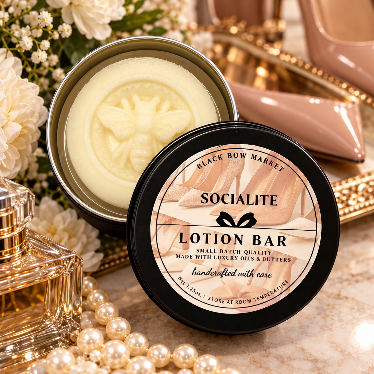 Socialite solid lotion bar in an open reusable tin with pearls and florals, handmade by Black Bow Market in Keller, Texas